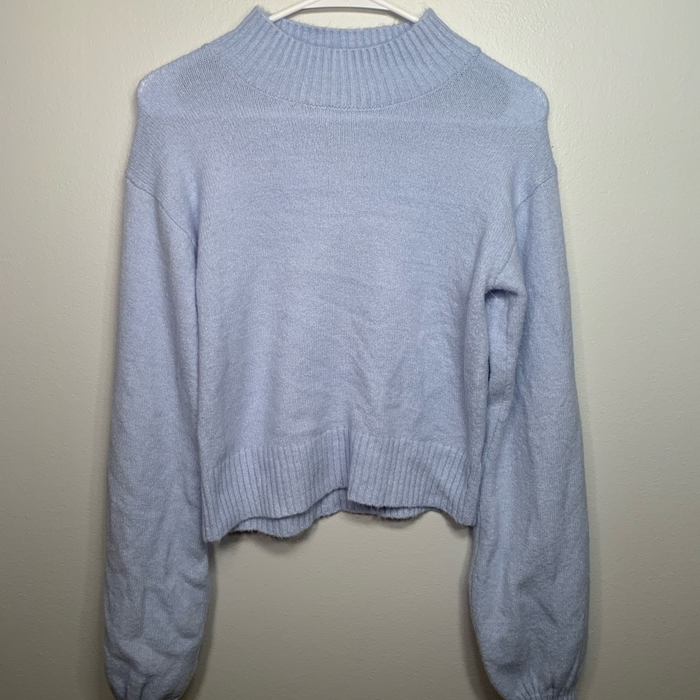 Light blue turtle neck sweater.